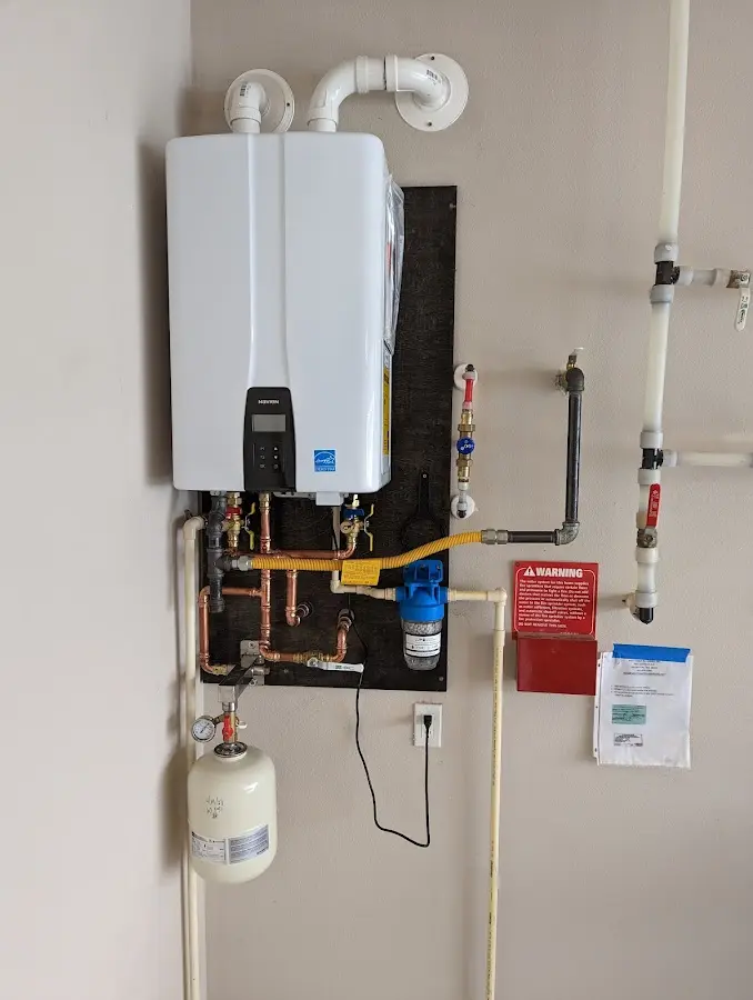 Professional plumber installing copper piping in a Scottsbluff home